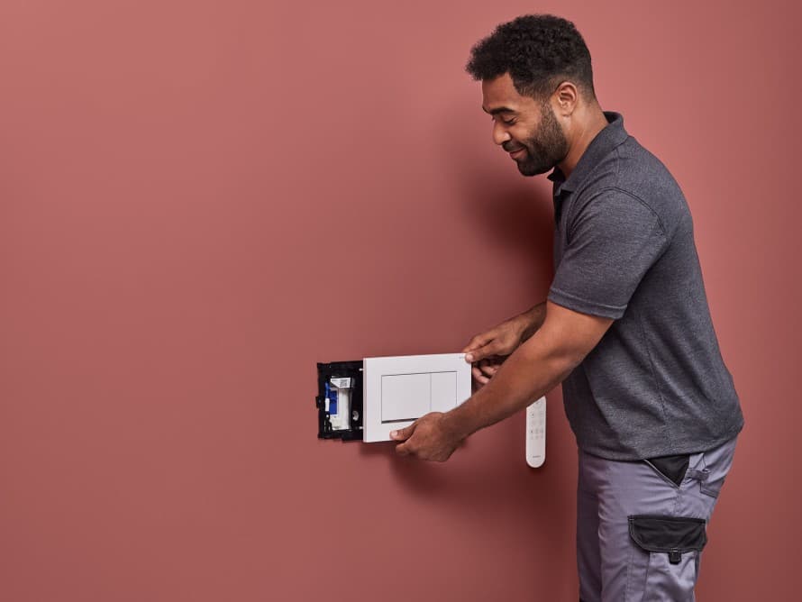 Homme installant le système d’absorption des odeurs Geberit DuoFresh Homme installant le système d’absorption des odeurs Geberit DuoFresh